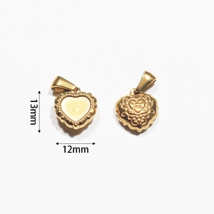 Detail of 13mm gold heart pendant showing embossed vine patterns and beaded edges