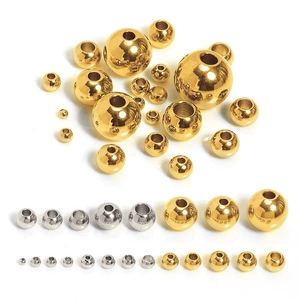 Close-up of assorted gold and silver stainless steel spacer beads for DIY jewelry making