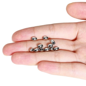 Polished stainless steel oval beads with holes for DIY jewelry making in a hand