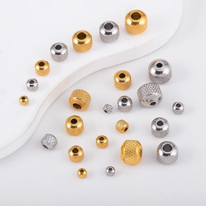 Detailed macro view of textured mesh stainless steel beads in gold and silver finishes