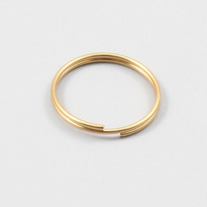 Detail of a polished golden 304 stainless steel split ring for DIY keychain hardware
