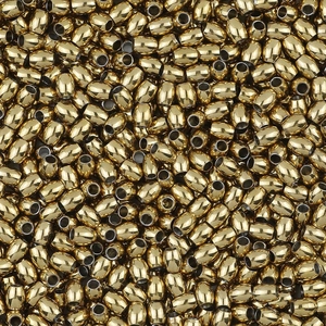 Pile of golden stainless steel barrel spacer beads with polished mirror finish for DIY jewelry