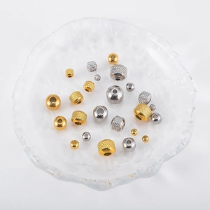 Macro detail of mixed gold and silver stainless steel spacer beads with knurled patterns