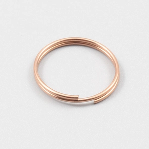 Detailed close-up of rose gold stainless steel split ring connector for keychains