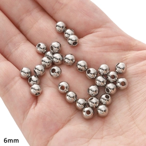Close-up of 6mm polished stainless steel beads for DIY jewelry making and crafting