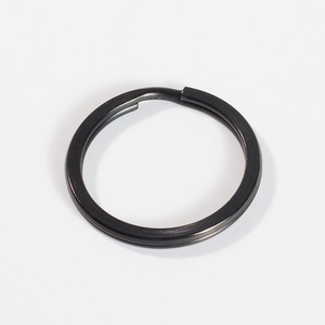 Detailed macro view of a flat black 304 stainless steel key ring with double-layered spiral
