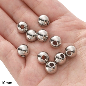 Detail showing 10mm polished stainless steel beads for DIY jewelry making in palm