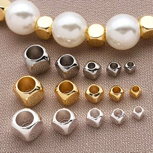 Détail macro de perles d'espacement cubiques en argent or et rose pour bijoux DIY