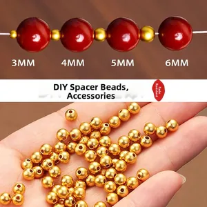 Macro detail of 3mm to 6mm gold stainless steel spacer beads for DIY jewelry making