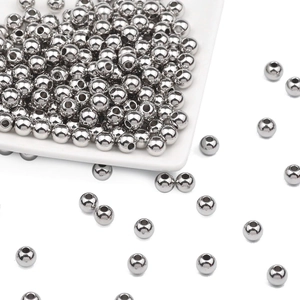 Macro detail of silver stainless steel beads with through-holes for DIY jewelry making