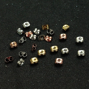 Close-up of assorted stainless steel butterfly earring backs in multiple metallic colors
