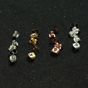 Macro shot of butterfly earring backs in silver gold rose gold and gunmetal finishes