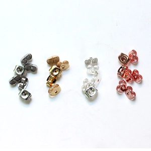 Detail of assorted butterfly earring backs in silver, gold, and rose gold finishes
