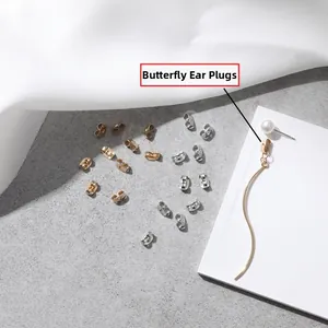 Detailed macro view of golden and silver stainless steel butterfly earring backs