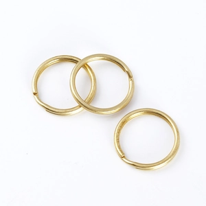 Three flat-wire golden brass key rings in minimalist circular design for DIY keychains