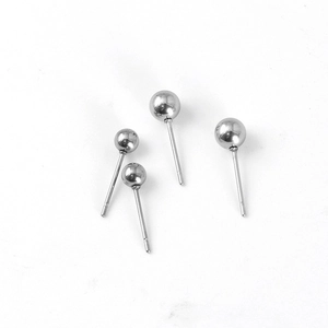 Macro shot of minimalist stainless steel ball stud earrings with polished silver finish