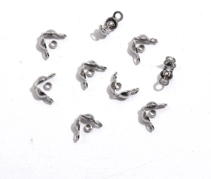 Macro view of polished stainless steel curved spacer beads for DIY jewelry making