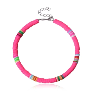 Close-up of pink handmade polymer clay bead anklet with colorful accents and lobster clasp