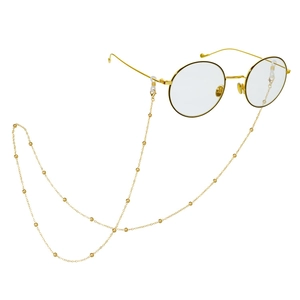 Golden round frame glasses with minimalist beaded chain lanyard shown on white background