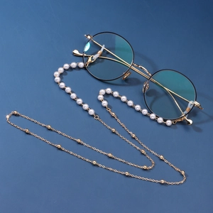 Elegant pearl and gold bead eyewear chain on black vintage round glasses for women