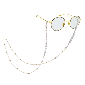 Detail view of pearl and gold beaded glasses chain with transparent non-slip loops
