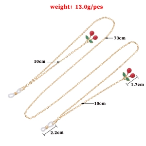 Golden eyeglass chain with red cherry pendants and silicone loops, 73cm length