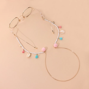 Colorful tassel and pompom beaded glasses chain with shells on a gold frame eyewear