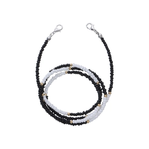 Close-up of black and white beaded chain with gold accents and lobster clasps