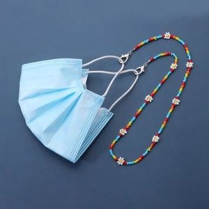 Colorful beaded daisy chain for glasses or masks with silver lobster clasps on blue background