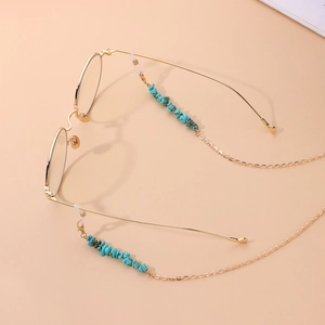 Lunettes à monture dorée avec chaîne en métal élégante et perles turquoise
