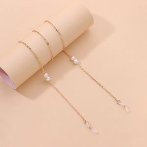 Détail d'une chaîne de lunettes dorée avec perles blanches et boucles en silicone
