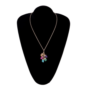 Golden chain necklace with five irregular colorful crystal stone pendants on black bust