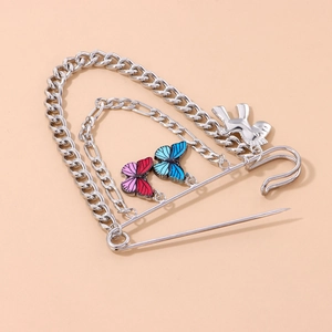 Silver pin brooch with multi-layered chains featuring enamel butterflies and a 3D bear charm