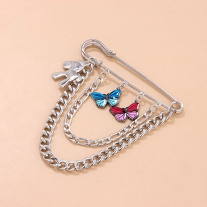 Silver safety pin brooch with colorful butterfly charms and chain fringe design