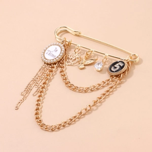 Punk vintage gold safety pin brooch with hanging chains, pearl disk, and crystal charms