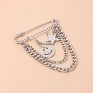 Silver safety pin brooch with layered chains, star charm, and engraved smiley face pendant