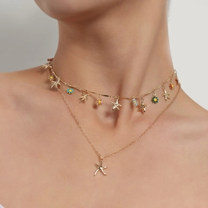 Double-layered gold starfish necklace with colorful enamel flowers and sea star charms