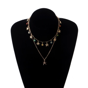 Double-layered gold necklace with starfish charms and colorful enamel flower pendants