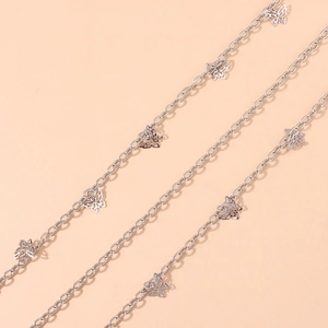 Close-up of a silver waist chain featuring multiple hollow butterfly metal charms