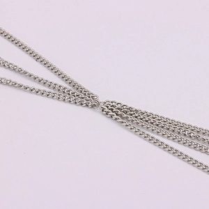 Detailed close-up of multi-layer silver cuban link chains with polished metal finish