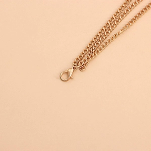 Punk style gold metallic body chain with curb link design and lobster clasp closure