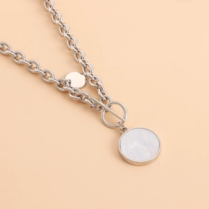 Detail of silver chain necklace featuring marble inlay pendants and an OT toggle clasp