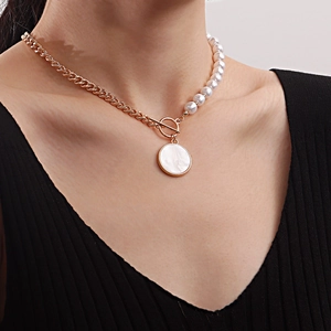 Asymmetric gold Cuban chain and pearl necklace with a shell pendant and OT buckle