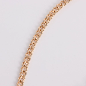 Detailed view of the gold-plated Cuban link chain with a glossy polished metal finish