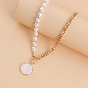 Macro detail of high-end pearl and gold chain necklace with toggle OT clasp and pendant