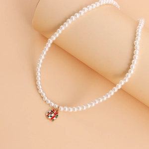 Detail of elegant pearl necklace featuring a red and green Christmas gift box enamel pendant