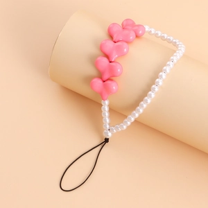 Detail of pink heart beads and white pearls on a stylish mobile phone lanyard charm