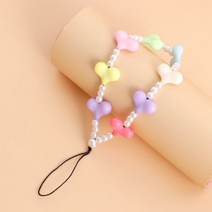 Close-up of colorful heart charms and faux pearls on a sweet candy-style phone strap