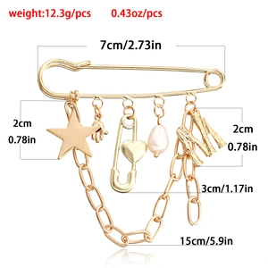 Gold safety pin brooch with star, hand, pearl and M charms, 12.3g metal jewelry