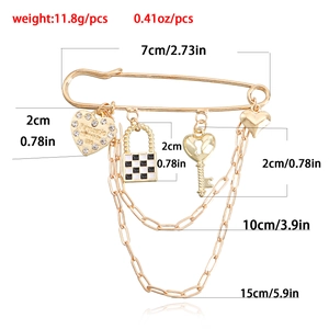 Retro brooch featuring heart pendants, checkered lock, key charms and metal chains